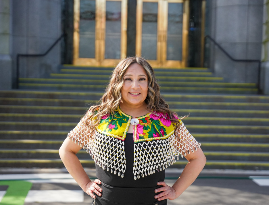 Rachel Sagastas Wuttunee standing outside a civic building